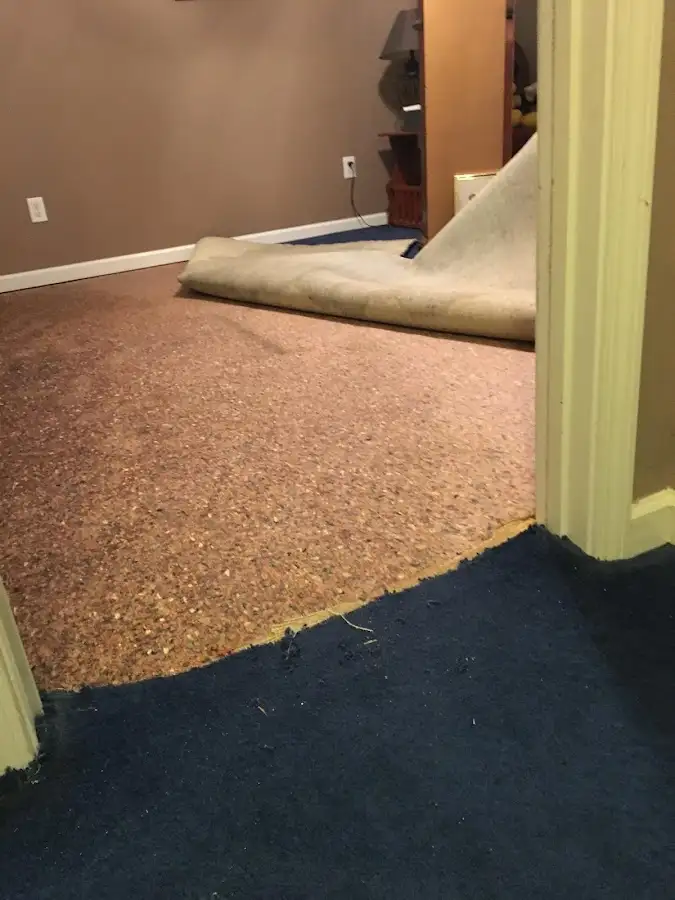 Carpet pad removal revealing water damage during Water Mitigation Services in Green Hill