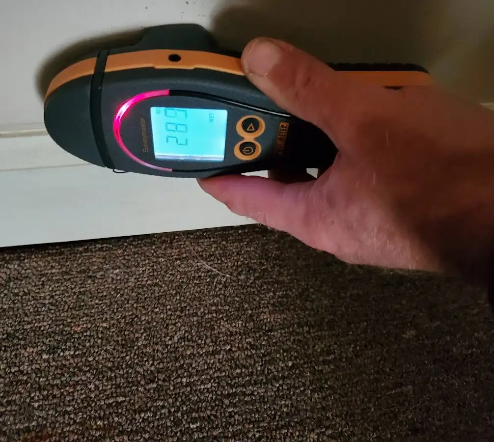 Moisture detection at baseboard during Storm Damage Restoration in Green Hill